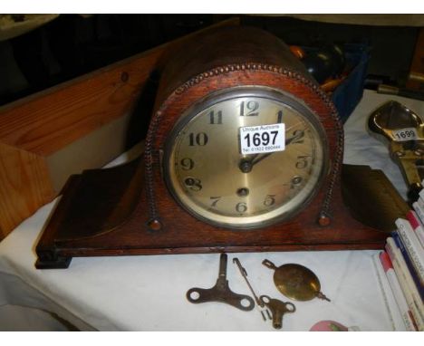 A 1920's oak mantel clock in working order.