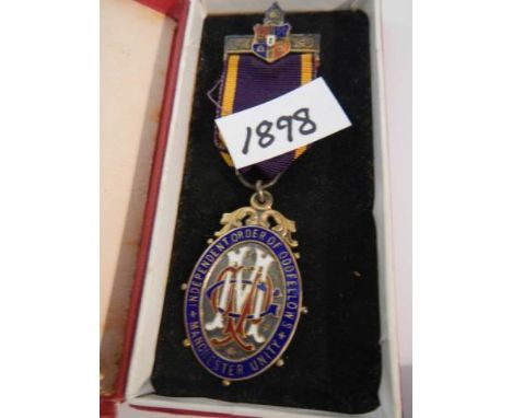A silver and enamel Order of the Oddfellows medal.