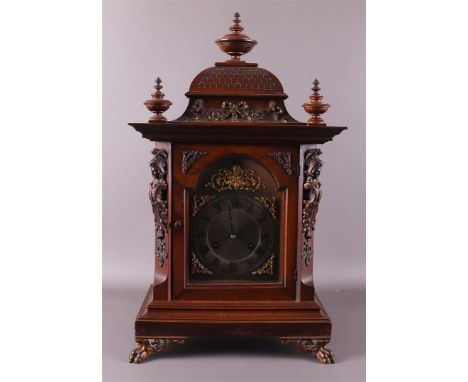 A table clock, Germany, Gründerzeit, late 19th century. Walnut housing, raised top with turned vase knobs as crown, dial with