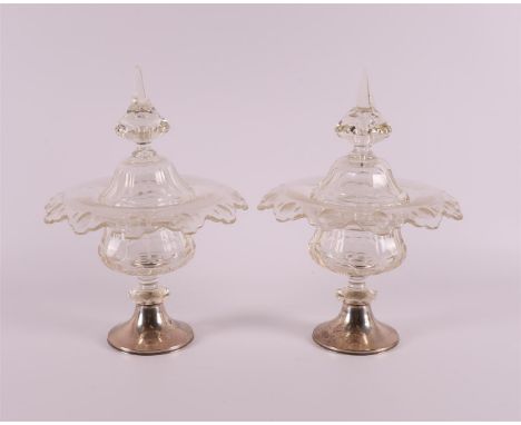 A set of crystal ginger lid coupes with folded contoured rim on a silver base, early 20th century. Decoration of faceted cut,