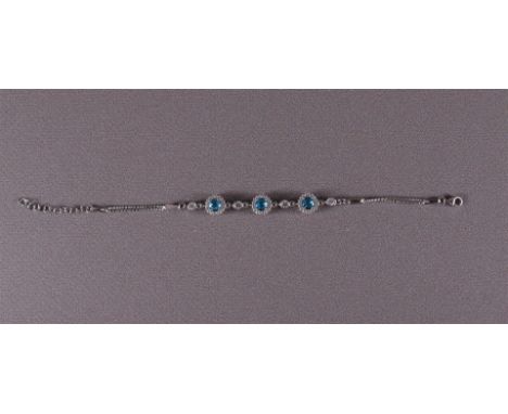 A 1st grade 925/1000 silver bracelet with facet cut light blue stones and zirconias.