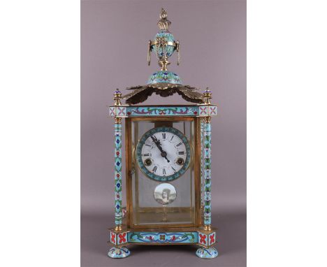 A table clock in cloissonné and brass casing, 20th century. Crowning of vase ornament on leaf ornament, supported by four pil