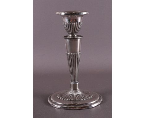 A second grade 835/1000 silver one-light candlestick in Empire style, 20th century, 158 grams gross. Height 16.5 cm. .