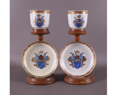 A pair of porcelain Chine de Commande cups and saucers, China, 18th century. Polychrome decoration of coat of arms with helme