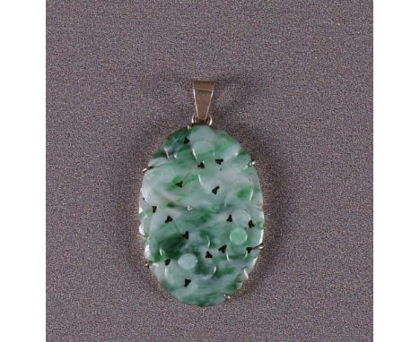 A gold on 2nd grade 835/1000 silver pendant and an oval carved jade with floral motifs.