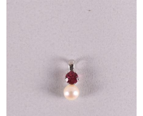 An 18 kt 750/1000 white gold pendant, set with ruby and pearl, gross weight 2.8 grams.