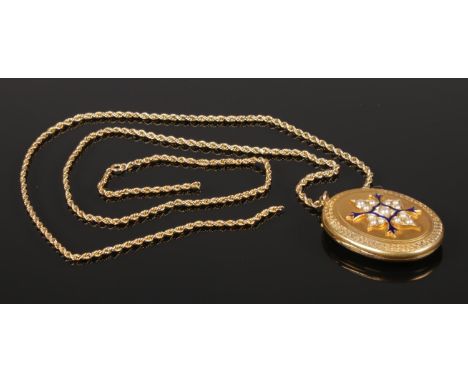 A yellow metal locket on 9ct gold chain. The locket having seed pearl and enamel decoration.  Chain broken.
