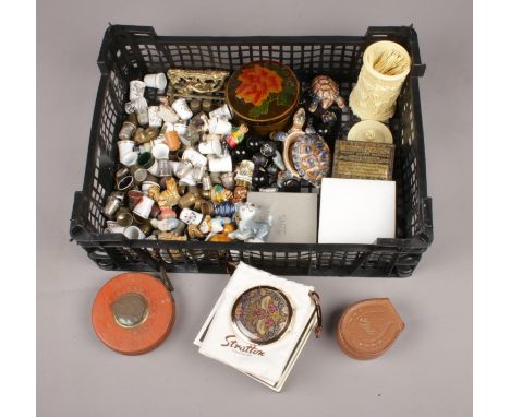 A box of collectables. Includes thimbles, buttons, Stratton compact, Wade etc.  