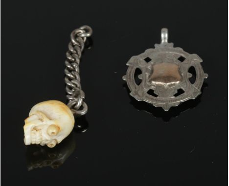 Two Watch Fobs. To include carved bone skull with London assay mark to mount &amp; white metal albert fob link in vintage ret