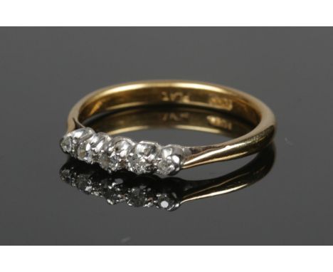 An 18ct gold and platinum five stone diamond ring. Size O, 3.32g.  