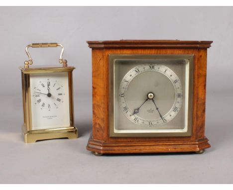 A figured walnut Elliott mantel clock on brass feet. 15cm height. presentation clock. To include a Taylor &amp; Bligh brass c