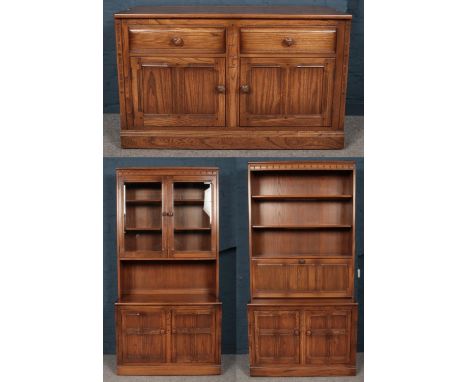 An Ercol golden dawn wall unit. Comprising of one side base unit with cupboard and drawers, one bookcase/ secretaire with cup