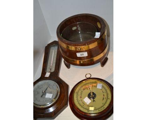 A 1930s oak barometer ; another; a coopered oak jardiniere stand by R.A. Lister and Co