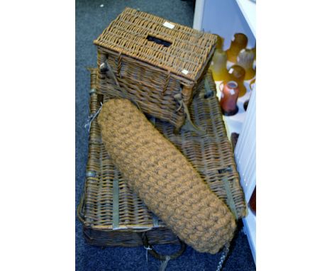A vintage wicker laundry basket, rope carrying handles; a wicker fishing basket; a boat rope bumper