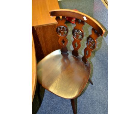 A set of four Ercol 'Prince of Wales Feathers' back dining chairs