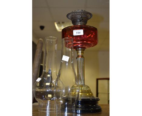 A Victorian oil lamp, cranberry glass reservoir