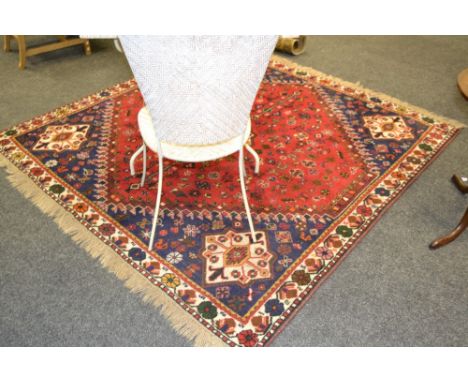 A Persian Qashqai  woollen carpet, with central red lozenge, within a blue ground, 197cm x 193cm