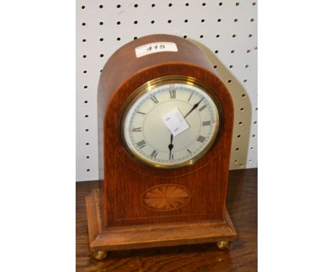 An early 20th century arched oak mantel clock, bat wing patera, c.1910 