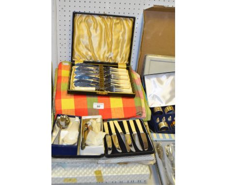 A set of Oneida cutlery, other boxed flatware including stainless steel carving set; table linen; a vintage First Aid tin ; e