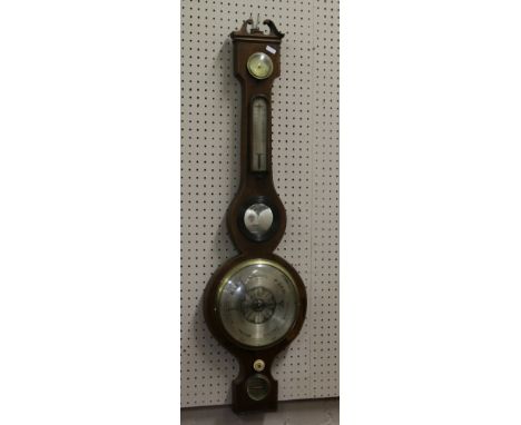 A Georgian mahogany banjo barometer with four engraved and silvered dials, with strung inlay and a convex mirror.