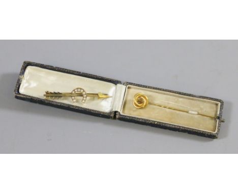 A Victorian gold bar brooch formed as an arrow and set with seed pearls along with a cased yellow metal stick pin.