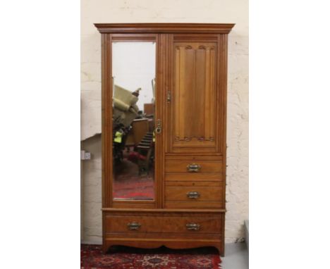 A Victorian mahogany mirrorfront wardrobe with carved linenfold door.