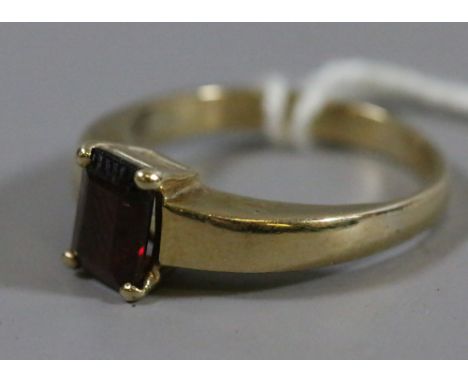 A ladies 9ct gold and faceted ruby ring.