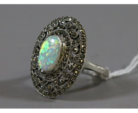 A ladies silver, marcasite and opal dress ring.