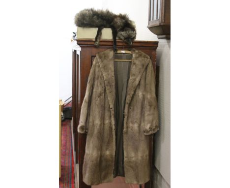 A three quarter length fur coat and a stole.