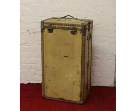 A vintage steamer trunk with wardrobe fitted interior locked and lacking key.