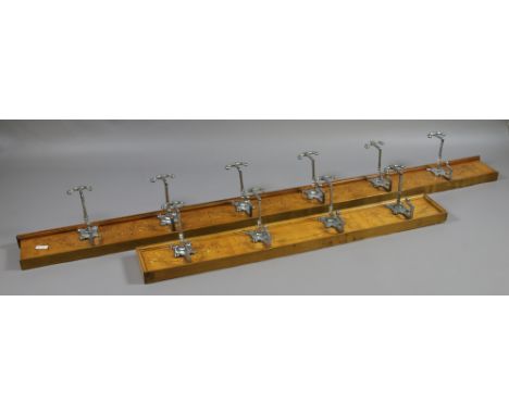 A pair of Edwardian marquetry inlaid satinwood coat pegs with stylized chrome plated hooks.