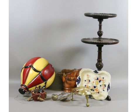 A decorative hanging hot air balloon along with a mahogany two tier table, brass and copper wares and a ceramic dish.