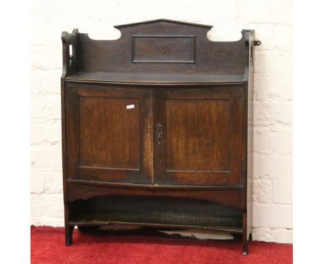 Oak wall shelf with fitted interior.