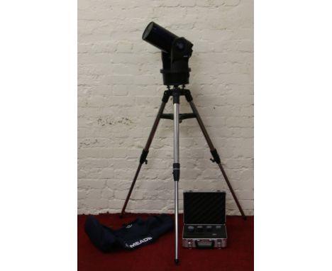 A Meade ETX telescope mounted on purpose made chrome tripod stand along with an alluminium case of matching lenses, carry bag