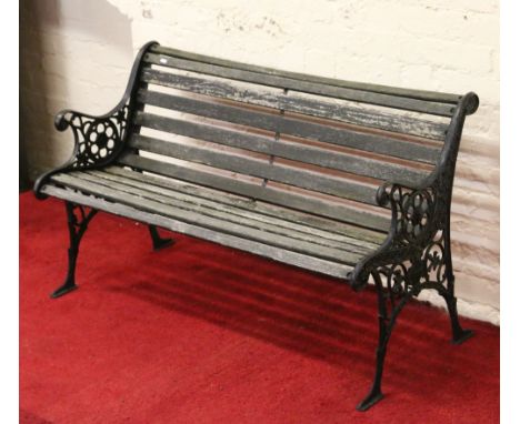 A cast iron and wood garden bench.