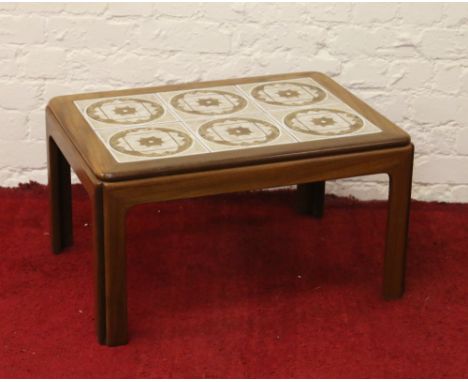 A retro 1970s teak and tile topped coffee table.