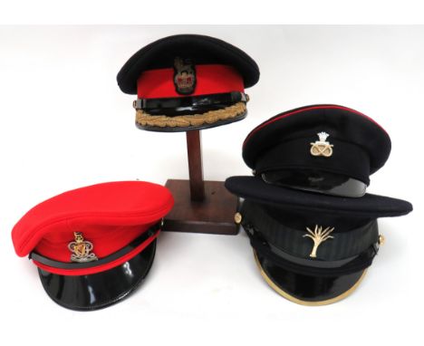 Four Various British Army Caps consisting Brigadier's dress cap. &nbsp;Dark blue with red band. &nbsp;Black peak with oak lea