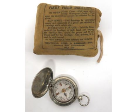 WW1 First Field Dressing And 1918 Compass unopened first field dressing dated July 1918. &nbsp;Together with a white metal, p