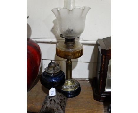 A Circular Based Brass Column Oil Lamp With Etched Glass Shade, Together With A Metalic Based Oil Lamp