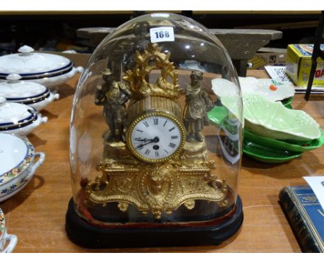 A Victorian Gilt Spelter Mantel Clock With Circular White Dial, Housed Under A Glass Display Dome