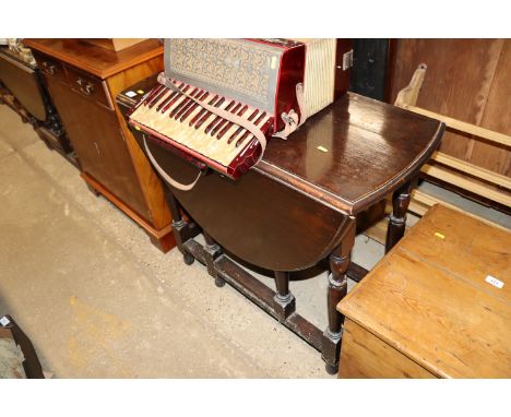 An antique oak gate leg dining table 