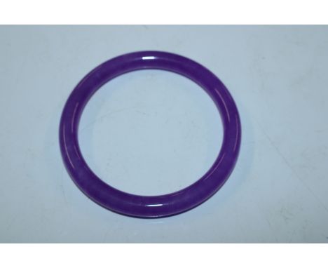 A lilac coloured jade type bangle 