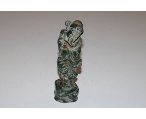 A carved jade type figure 