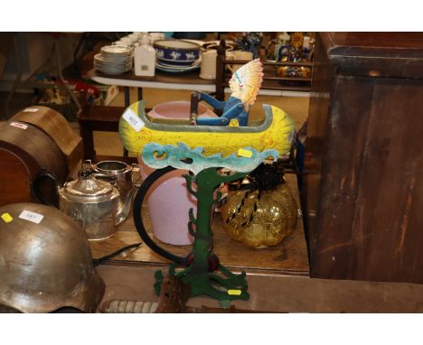 An unusual metal ware automaton depicting a Red Indian in a canoe 