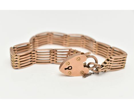 A ROSE METAL GATE BRACELET, a six bar gate bracelet, fitted with a heart padlock clasp, approximate width 9mm, stamped 9ct, a