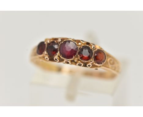 A 15CT GOLD MID VICTORIAN GARNET RING, five circular cut garnets set in yellow gold, scrolling detail to the gallery and shan