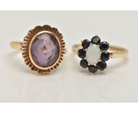 TWO GEM SET RINGS, the first an oval opal set with a surround of circular cut sapphires, prong set in yellow gold, hallmarked