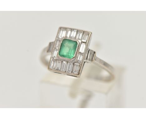 A WHITE METAL EMERALD AND DIAMOND RING, Art Deco style, the centre set with an emerald cut emerald in a milgrain collet setti