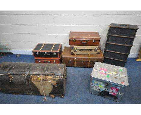 A VARIETY OF TRAVELING TRUNKS, to include two wooden banded and canvas trunks, a distressed large leather trunk, a metal trun