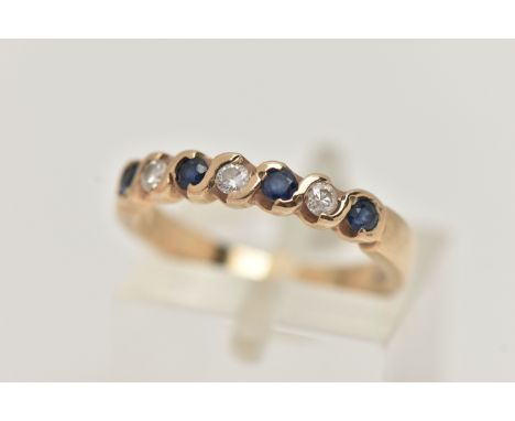 A SAPPHIRE AND DIAMOND SEVEN STONE RING, set with four circular cut sapphires, each measuring approximately 2.2mm diameter, i